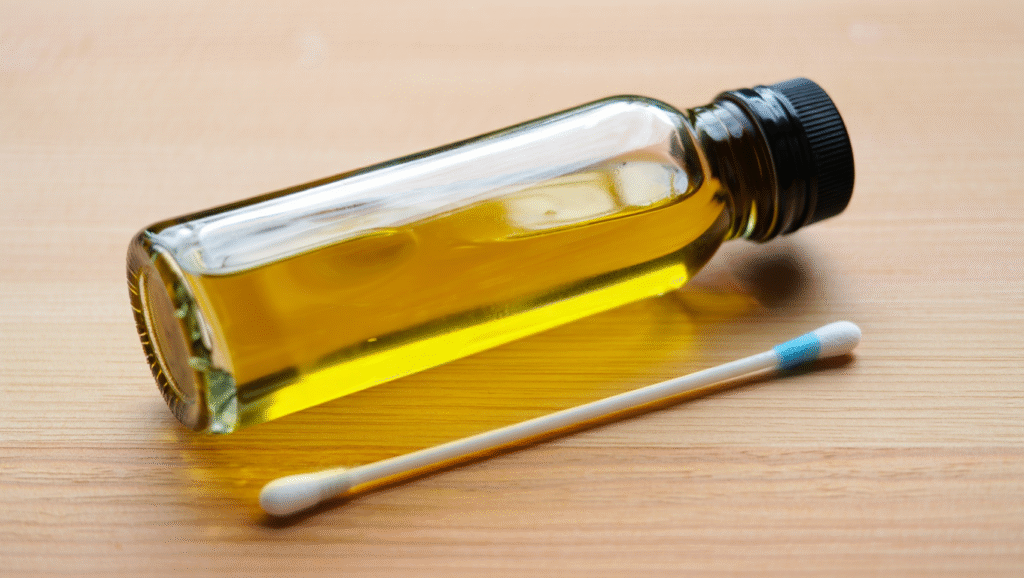 Un coton tige avec de l'huile d'olive sur une table